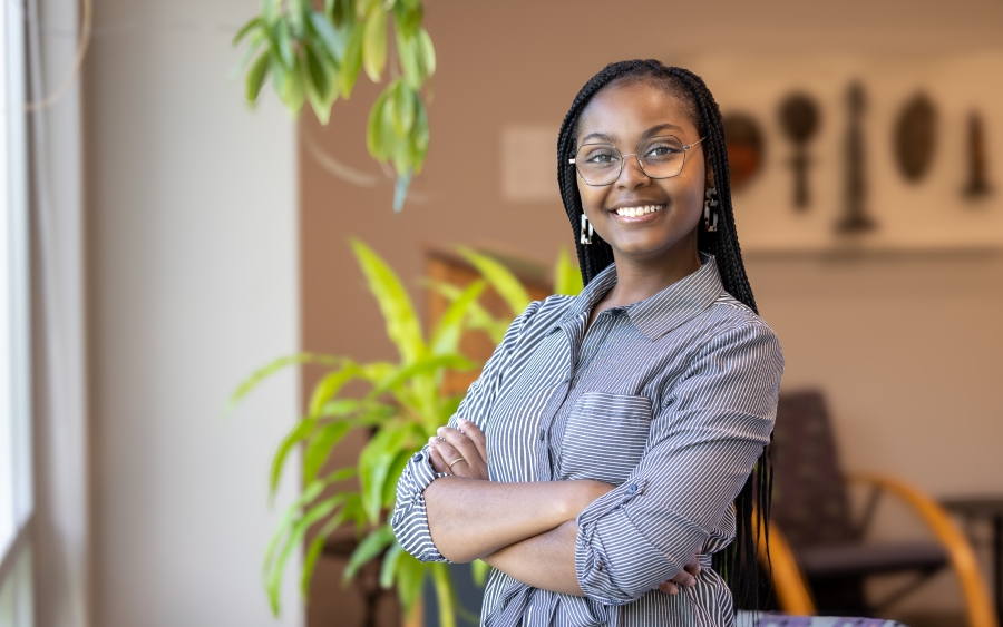 Photo of Lourena De Abreu - a young woman with her arms crossed smiling into the camera