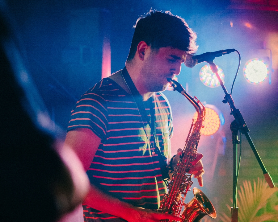 Photo of Evan Starr playing saxophone on stage.