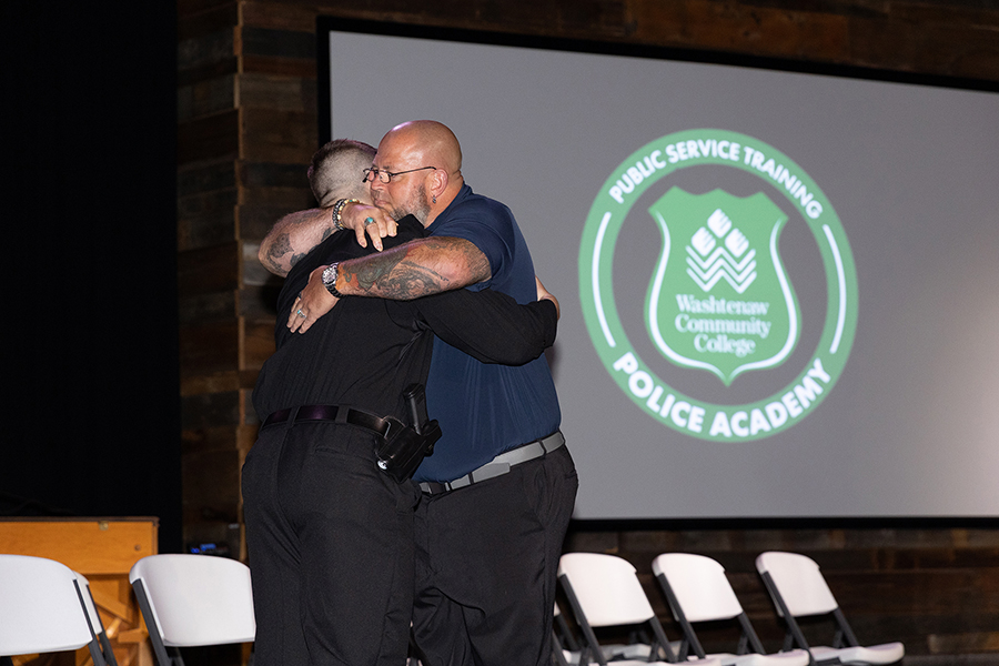 Father congratulating Police Academy graduate